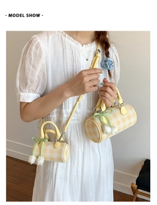 Detail of yellow checkered cylinder bags with tulip pendant and ribbon decoration