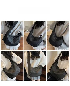 Macro detail of large black nylon crossbody bag showing water-resistant fabric and zippers