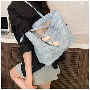 Light blue pleated tote bag with plush bear charm showing large capacity for essentials