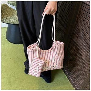 Detail of red striped canvas tote bag with surf boardy embroidery and matching pouch