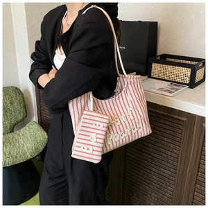 Detail of red and white striped canvas tote bag set with custom Bag Poardy embroidery