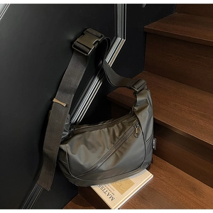 Close-up of functional nylon crossbody bag with durable plastic buckle and metal zipper detail