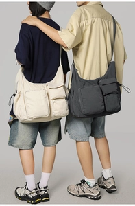 Detail of multi-pocket utility messenger bag showing durable nylon texture and zippers