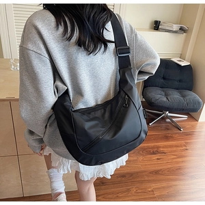 Detail view of the black crescent crossbody bag made of durable water-resistant nylon fabric