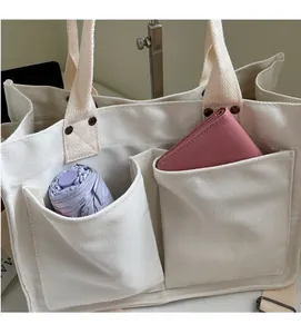 Detail view of durable canvas tote bag pockets with folded umbrella and wallet stored inside