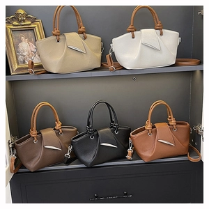 Detailed view of lychee texture pleated tote bags in five assorted colors on shelves