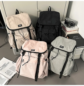 Detailed flat lay of four colorful water-resistant nylon backpacks with D-buckles and straps
