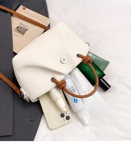 Detail view of beige lychee pattern bag showing large capacity for makeup and smartphone