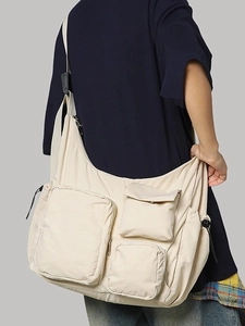 Off-white multi-pocket nylon messenger bag with adjustable drawstring for daily commute