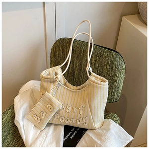 Detail of striped canvas tote bag with 3D embroidery and matching mini coin purse