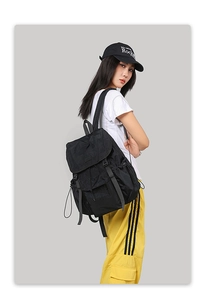 Side view of black outdoor backpack featuring drawstring closure and side adjustment straps