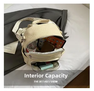 Interior view of beige lychee leather backpack showing large storage space for essentials