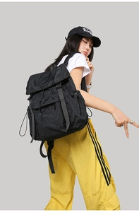 Outdoor black nylon backpack with flap drawstring closure and side pockets detail