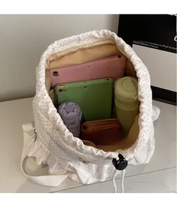 Internal view of polka dot backpack showing spacious storage with laptop and water bottle