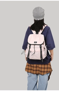 Rear view of pink outdoor backpack featuring clip buckles and multiple storage pockets