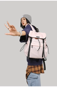 Pink high-capacity outdoor backpack with double buckle flap and drawstring closure on model