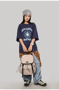 Detail of beige outdoor backpack with drawstring closure and large front zip pocket