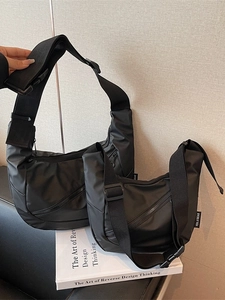 Two black nylon crescent crossbody bags in medium and small sizes with wide straps