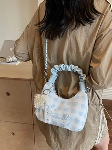 Blue plaid dumpling handbag with ruffle handle and pearl heart charm on a chain
