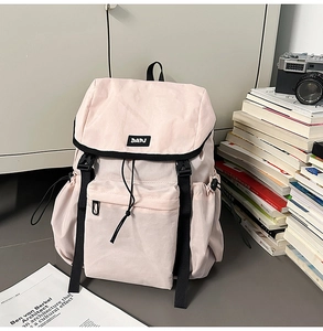 Close-up of pink nylon outdoor backpack with DAPJ logo and buckle closure detail