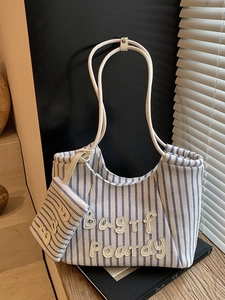 Blue striped canvas tote bag with letter patch and matching small pouch for daily commute