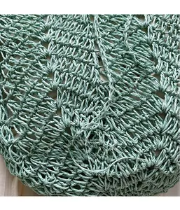 Close-up of light green hollow knit texture and 3D woven pattern on the summer tote bag