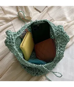 Detail shot of green woven bag interior showing spacious capacity for daily essentials