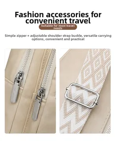 Detail of adjustable geometric woven strap and dual metal zippers on a beige crossbody bag