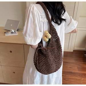 Brown knit hobo bag with thick woven texture and spacious interior for daily essentials