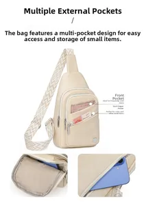 Detail of ivory sling bag showing multiple zip pockets and wide geometric woven strap