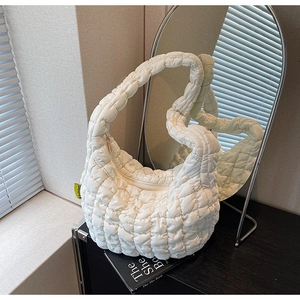 Detail of white quilted puffy cloud bag showing soft texture and Fashion label