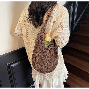 Macro detail of brown hand-woven crochet tote bag showing artisan herringbone texture