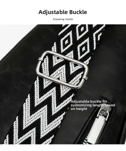 Detail of adjustable patterned shoulder strap with silver metal buckle on black chest bag