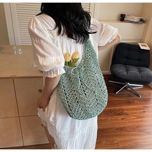 Detail of mint green crochet hobo bag with diamond hollow weave and tulip accents
