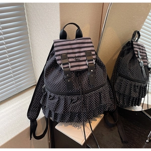 Close-up of polka dot backpack featuring ruffled layers and Hello embroidery detail