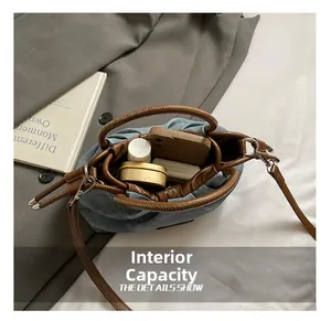Internal view of blue denim bag showing large capacity for phone and accessories