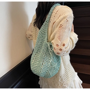 Detail of mint green hollow crochet knit tote bag showing intricate wavy edge texture