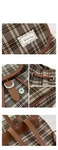 Detailed macro view of the checkered canvas backpack featuring drawstring and faux leather trim