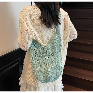 Detail of mint green crochet knit tote bag showing hollow mesh texture and large capacity