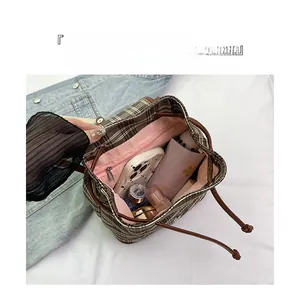 Macro detail of the spacious checkered canvas backpack interior with zipper pocket