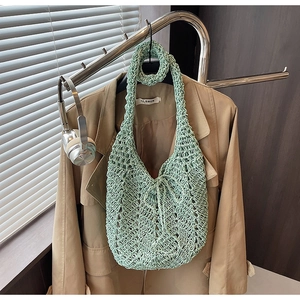 Detail of light green crochet knit tote bag with hollow pattern and matching scrunchie