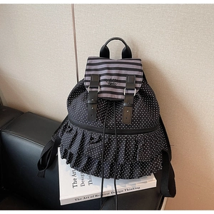 Detail of ruffle layers and Hello embroidery on striped polka dot backpack