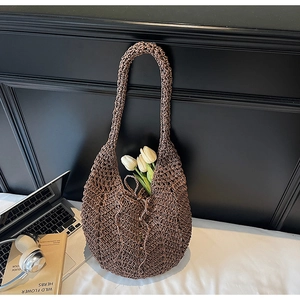 Detailed view of dark brown woven cotton rope shoulder bag with hollow mesh pattern