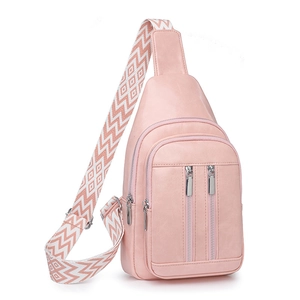 Detailed side view of pink crossbody bag with a geometric woven strap and silver zippers