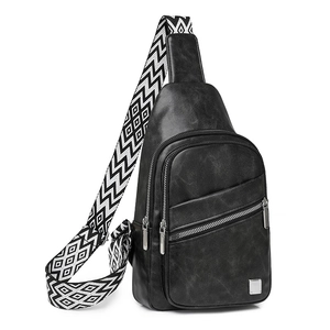 Detail of vintage black chest bag with multi-layer zippers and geometric woven strap