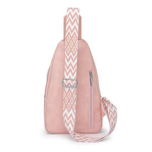 Detail of pink faux leather crossbody bag with wide geometric pattern strap and silver zipper