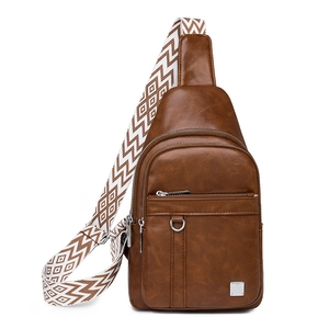 Detail view of brown PU leather crossbody bag featuring an ethnic geometric patterned strap