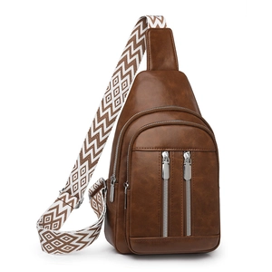 Macro detail of brown faux leather bag with vintage texture and ethnic woven strap