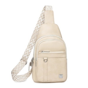 Detail of cream sling bag with textured leather and geometric pattern wide strap