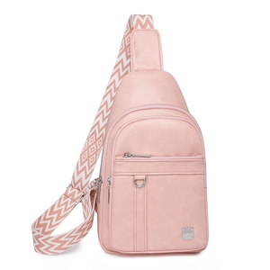Detail of light pink crossbody chest bag featuring woven patterned strap and PU texture